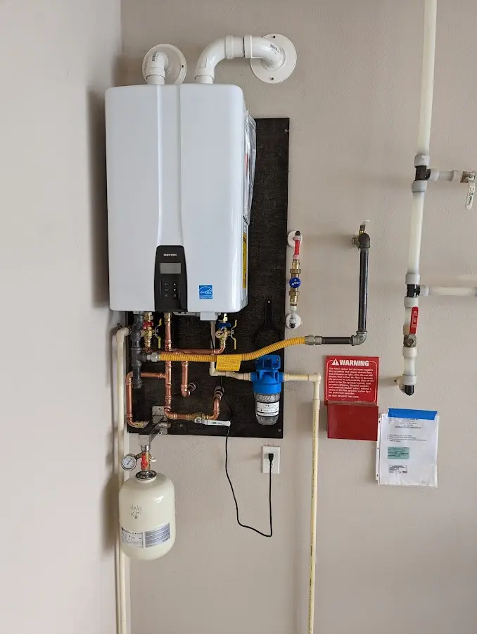 Professional plumber installing copper piping in a East Windsor home